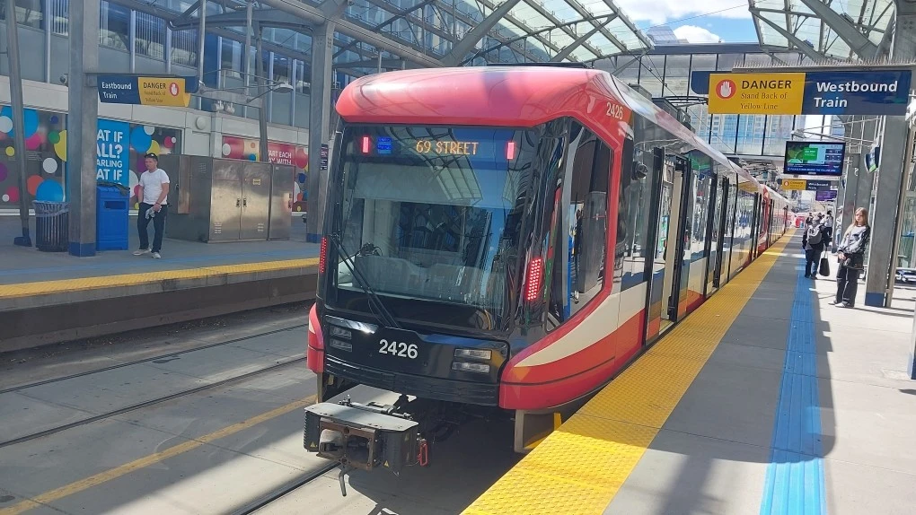 A newer C-Train LRT vehicle stopped at City Hall / Bow Valley College Westbound Platform, bound for 69th street.