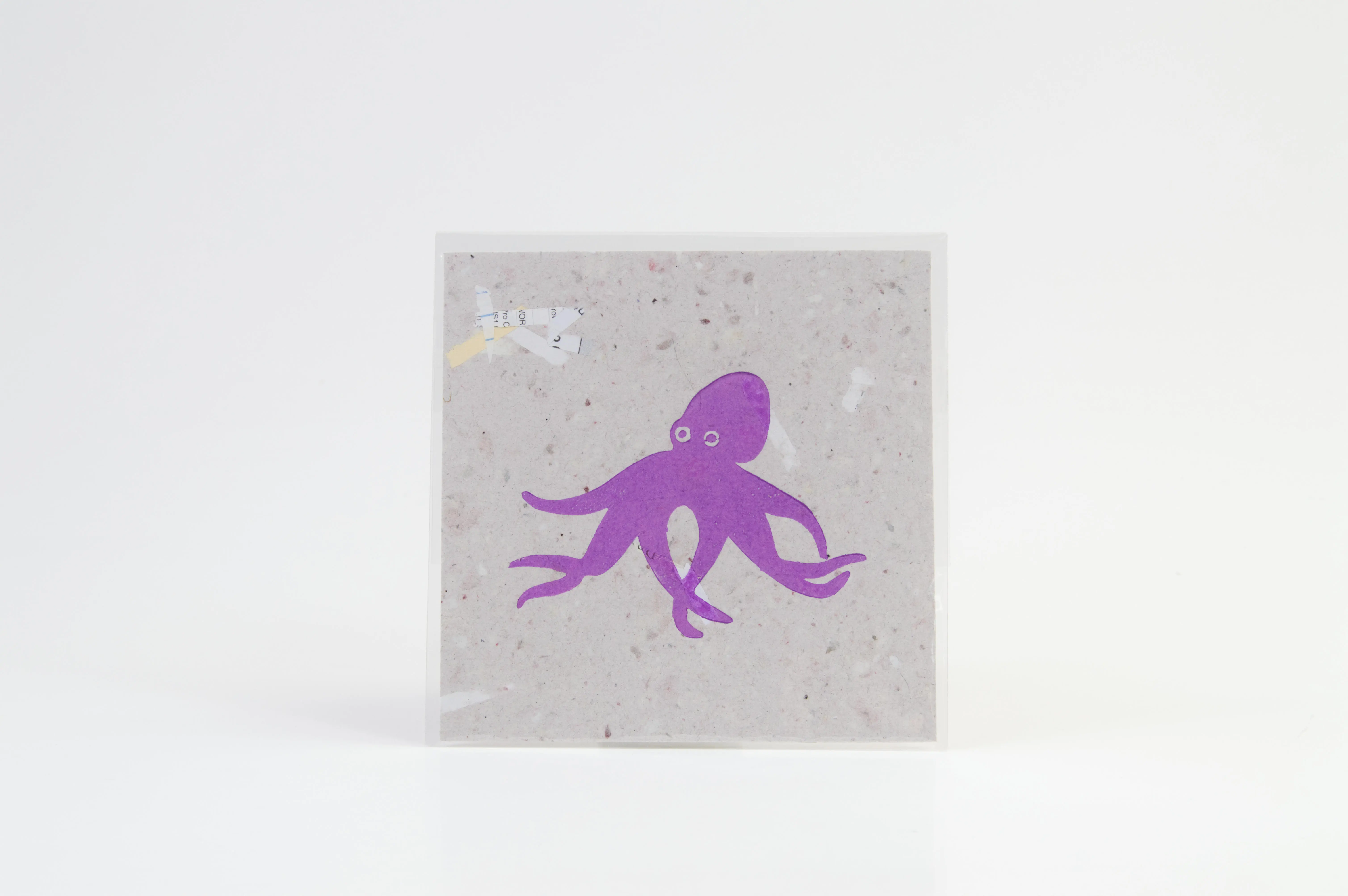 A relief print of a purple octopus.