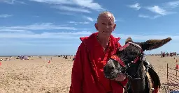 Seaside donkey owner weighing kids before they ride